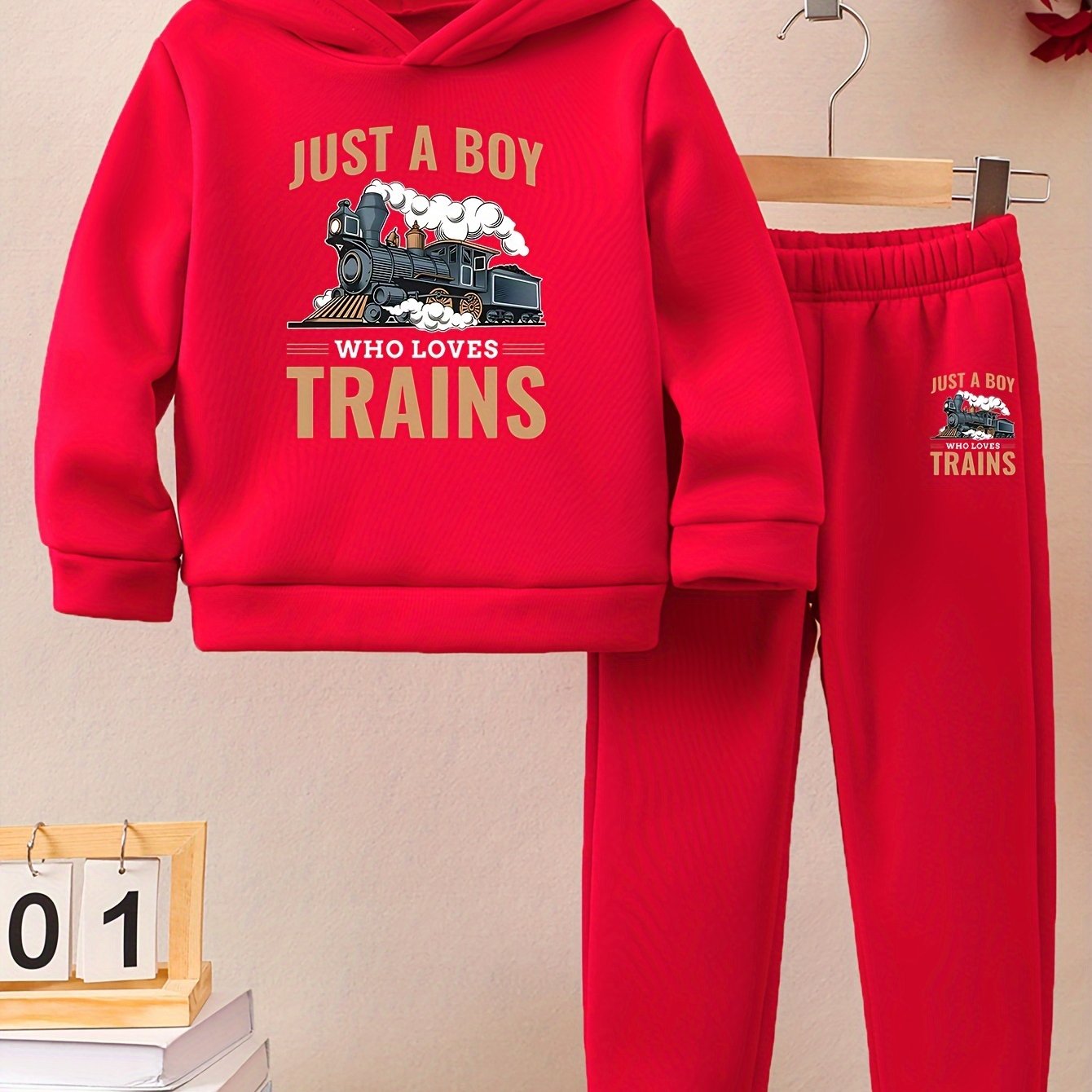 A Boy's Hooded Sweatshirt And Sports Pants With Train Pattern Print