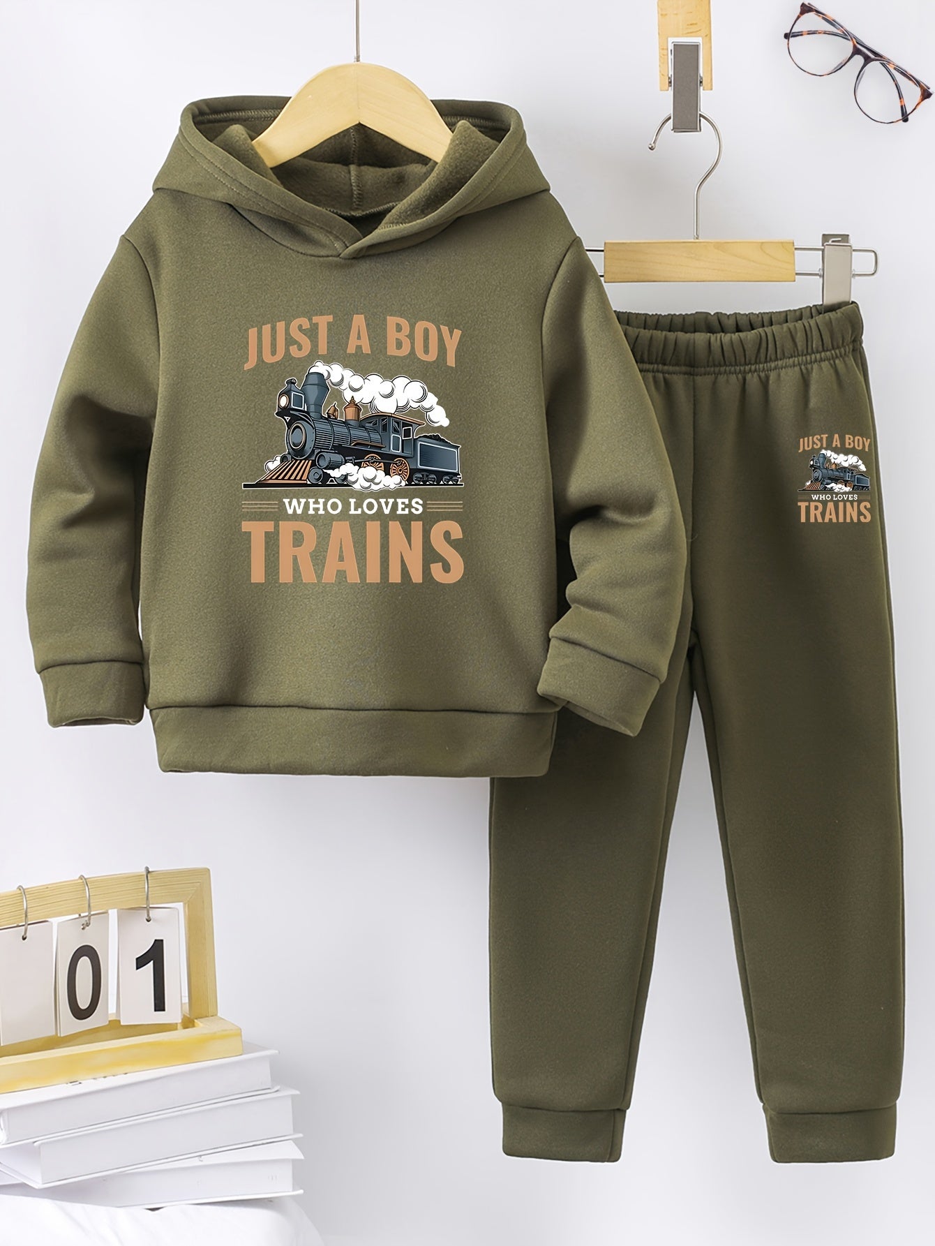 A Boy's Hooded Sweatshirt And Sports Pants With Train Pattern Print