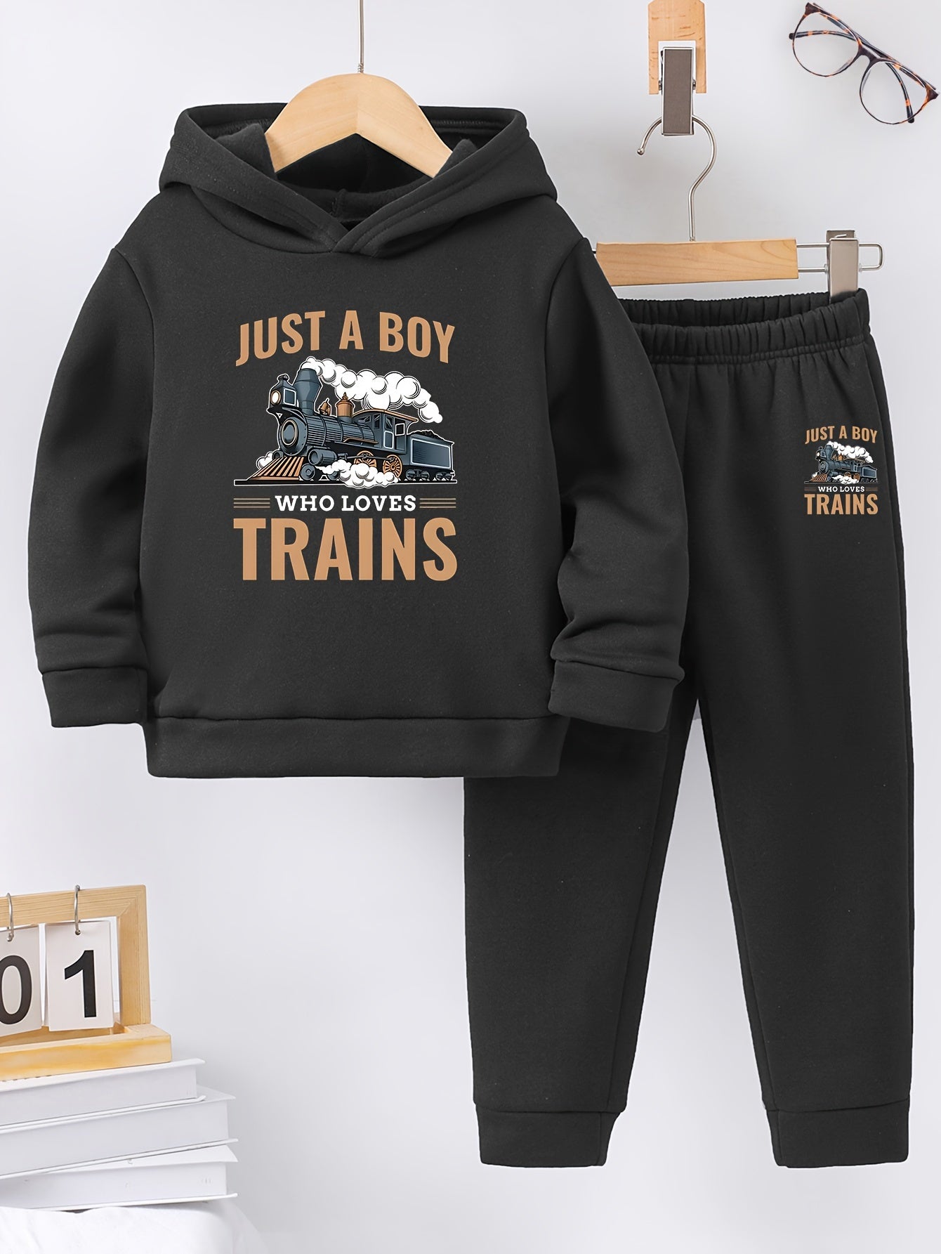 A Boy's Hooded Sweatshirt And Sports Pants With Train Pattern Print