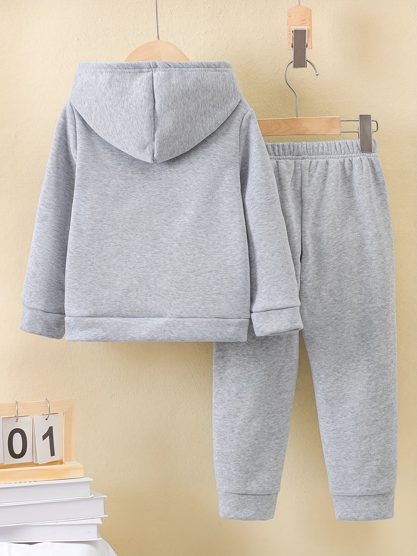 A Boy's Hooded Sweatshirt And Sports Pants With Train Pattern Print